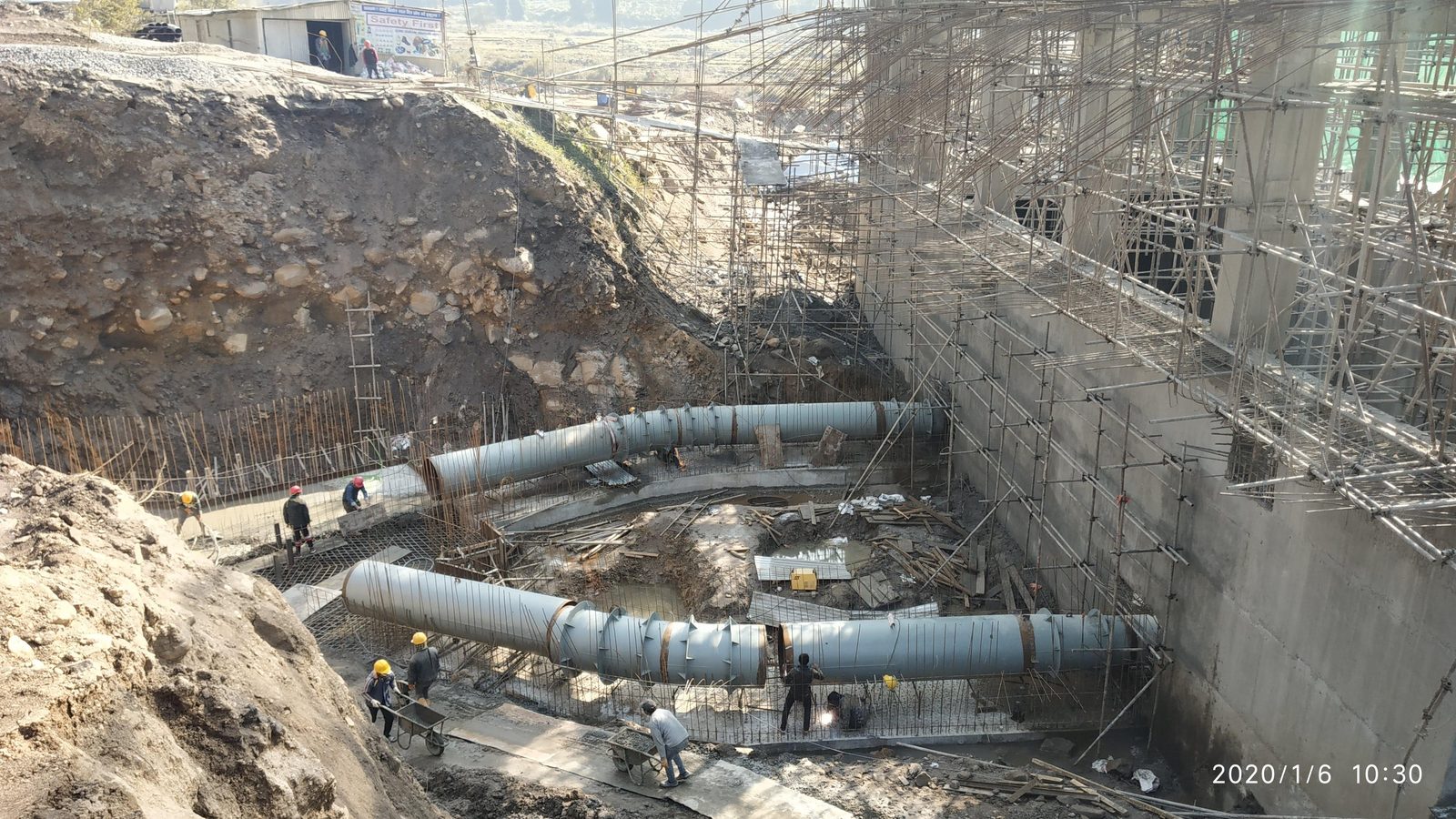 Branched penstock installation beside a hydropower powerhouse